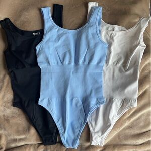 Set of three bodysuit tank tops. Size medium.